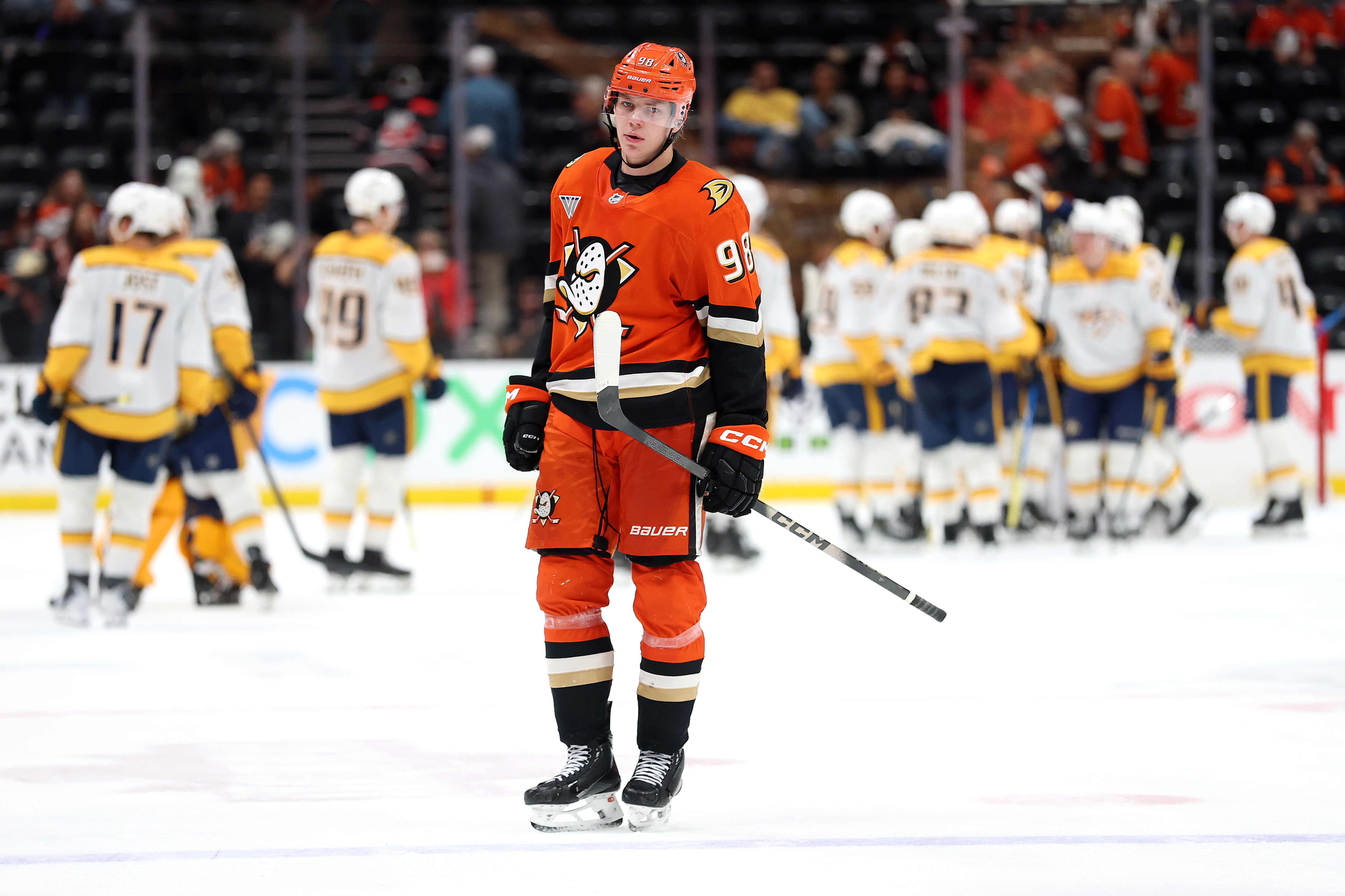 The Nashville Predators celebrate as the Ducks’ Pavel Mintyukov looks...