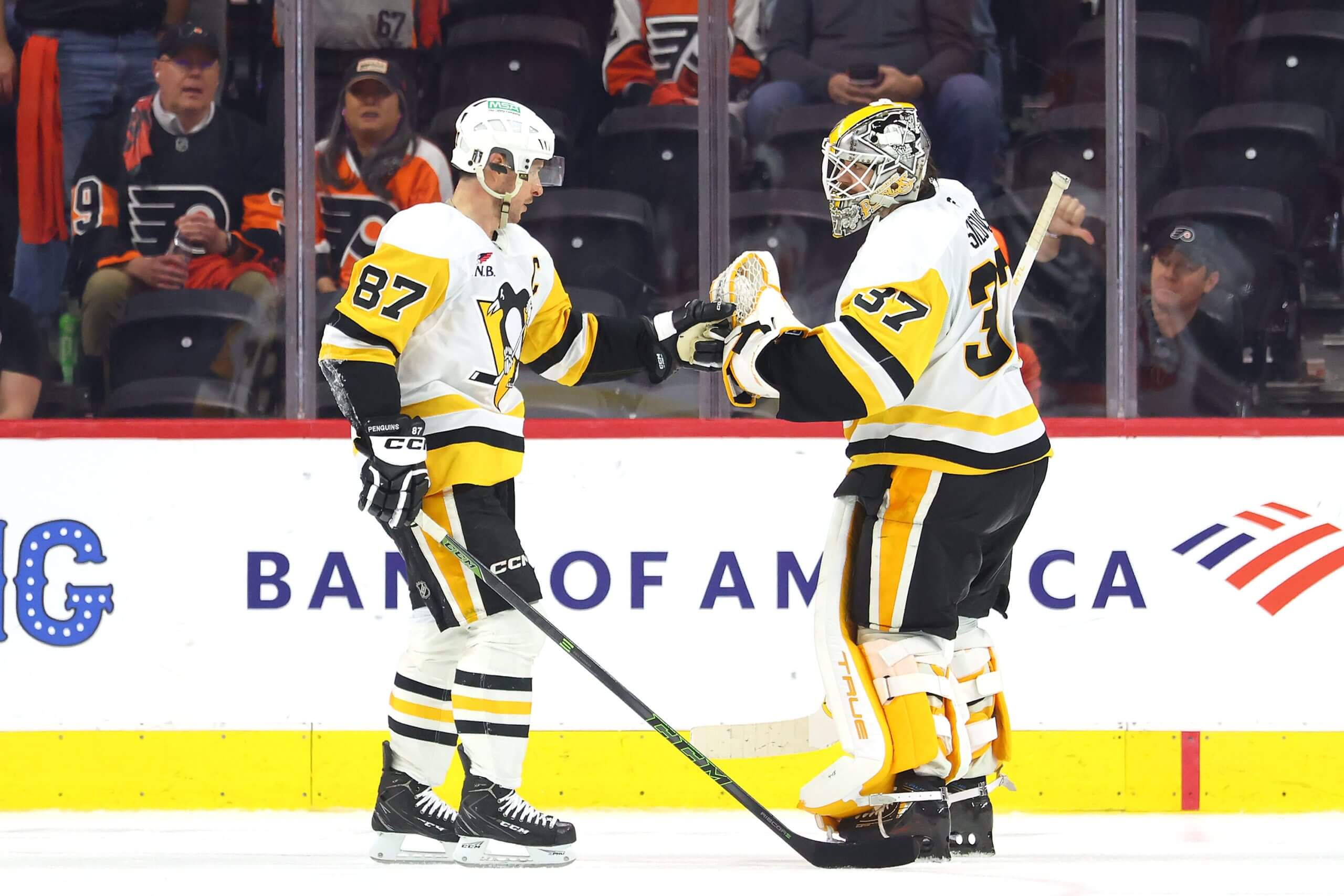 Sidney Crosby, left, and Artūrs Šilovs bump fists after the win.