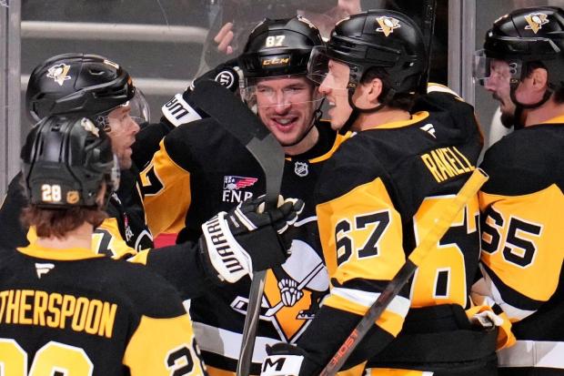 Pittsburgh Penguins' Sidney Crosby (87) celebrates his goal during the first period of an NHL hockey game against the Carolina Hurricanes in Pittsburgh, Tuesday, Dec. 30, 2025. (AP Photo/Gene J. Puskar)