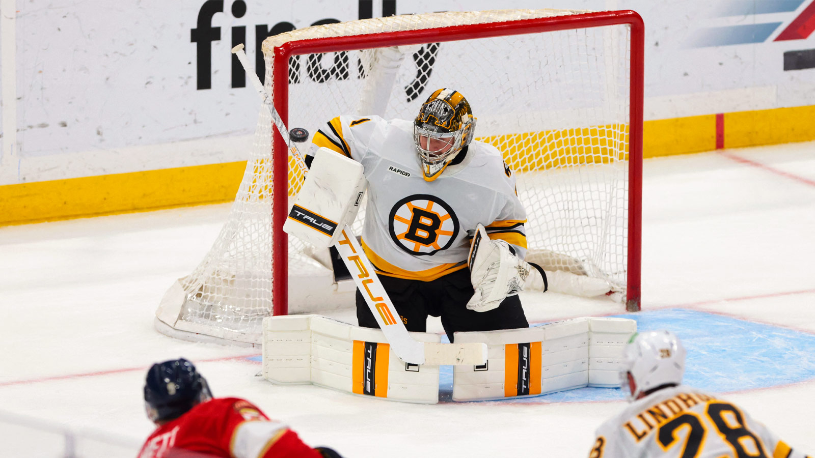 Boston Bruins goaltender Jeremy Swayman (1) makes a save against Florida Panthers center Sam Bennett (9) during the third period at Amerant Bank Arena. 