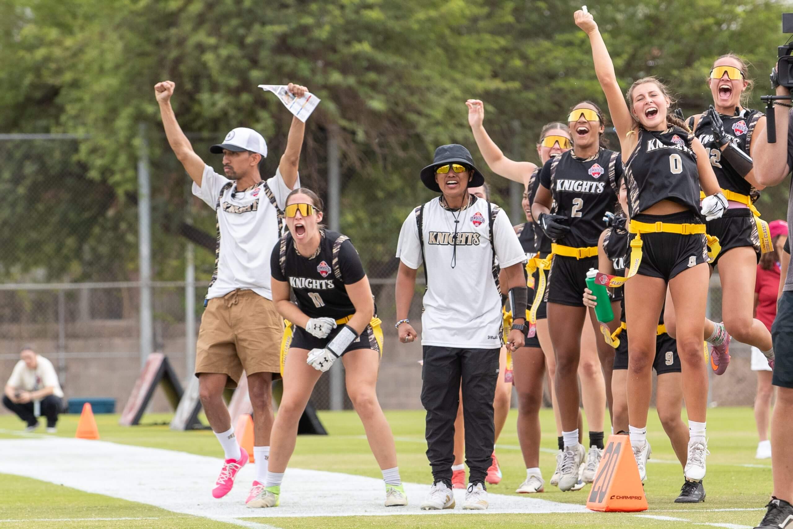 UCF players cheer from the sideline. 