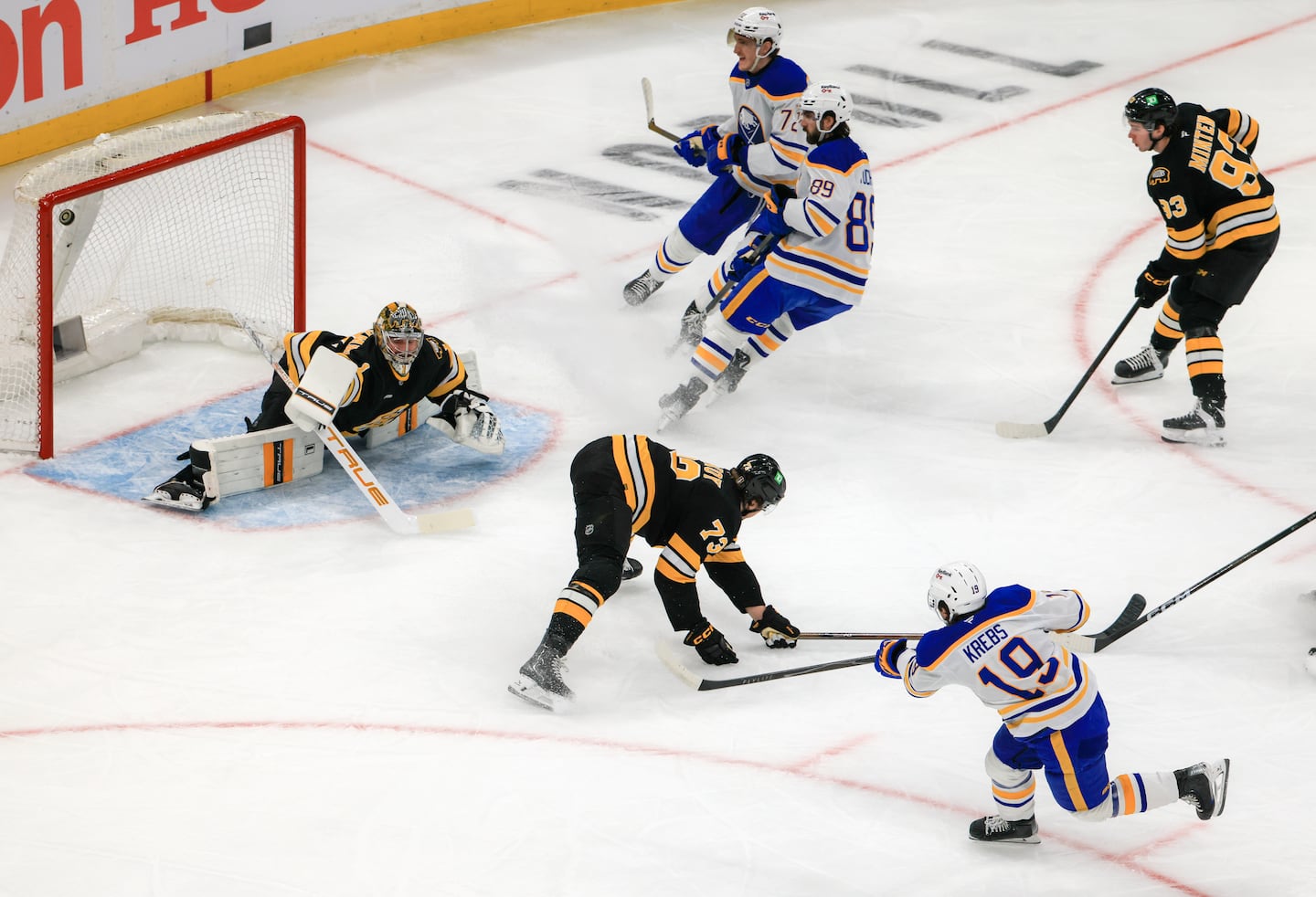 Peyton Krebs (19) scores a goal beating Bruins defenseman Charlie McAvoy (73) and goaltender Jeremy Swayman.