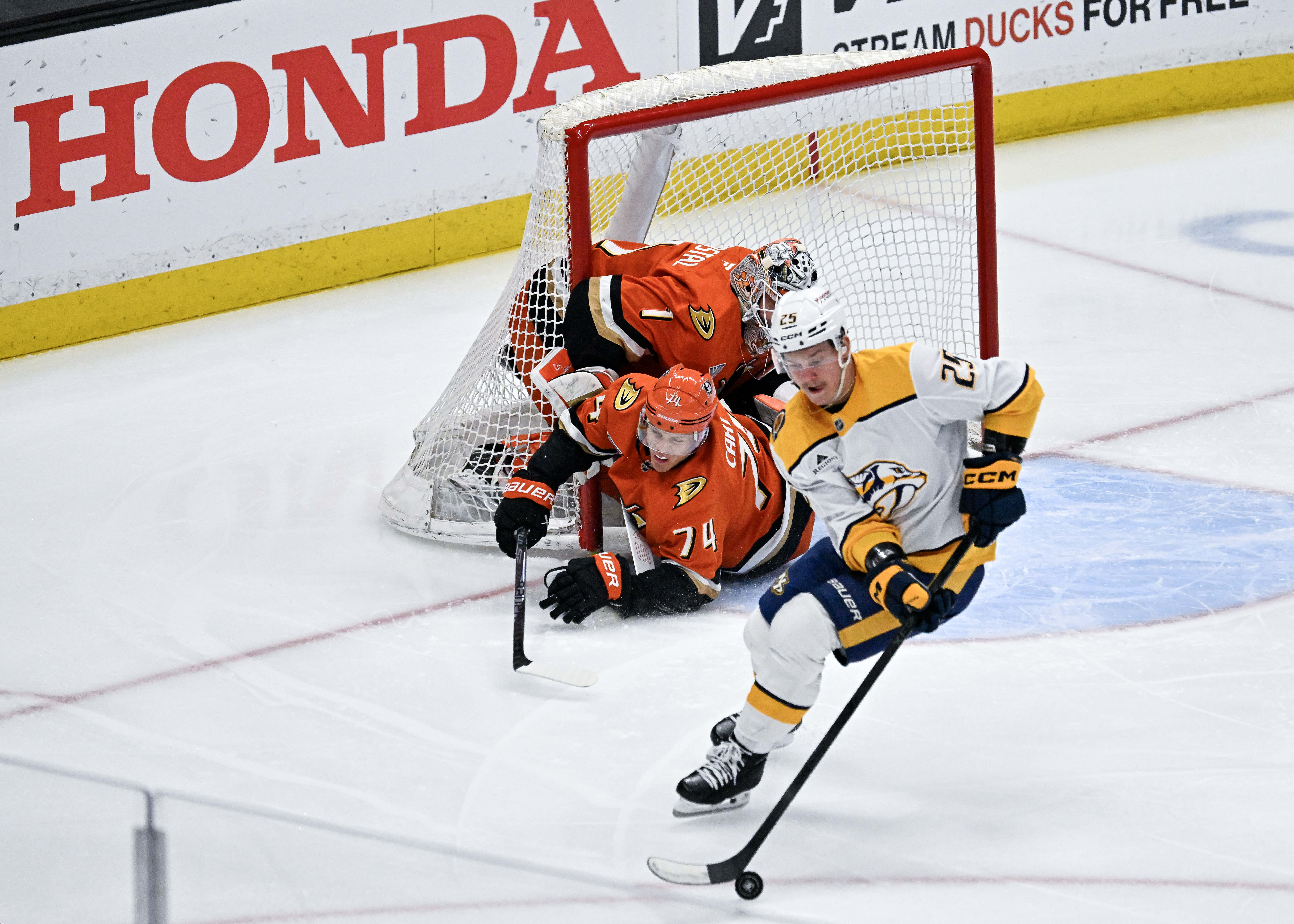The Ducksâ John Carlson (74) accidentally slides into goaltender Lukas...
