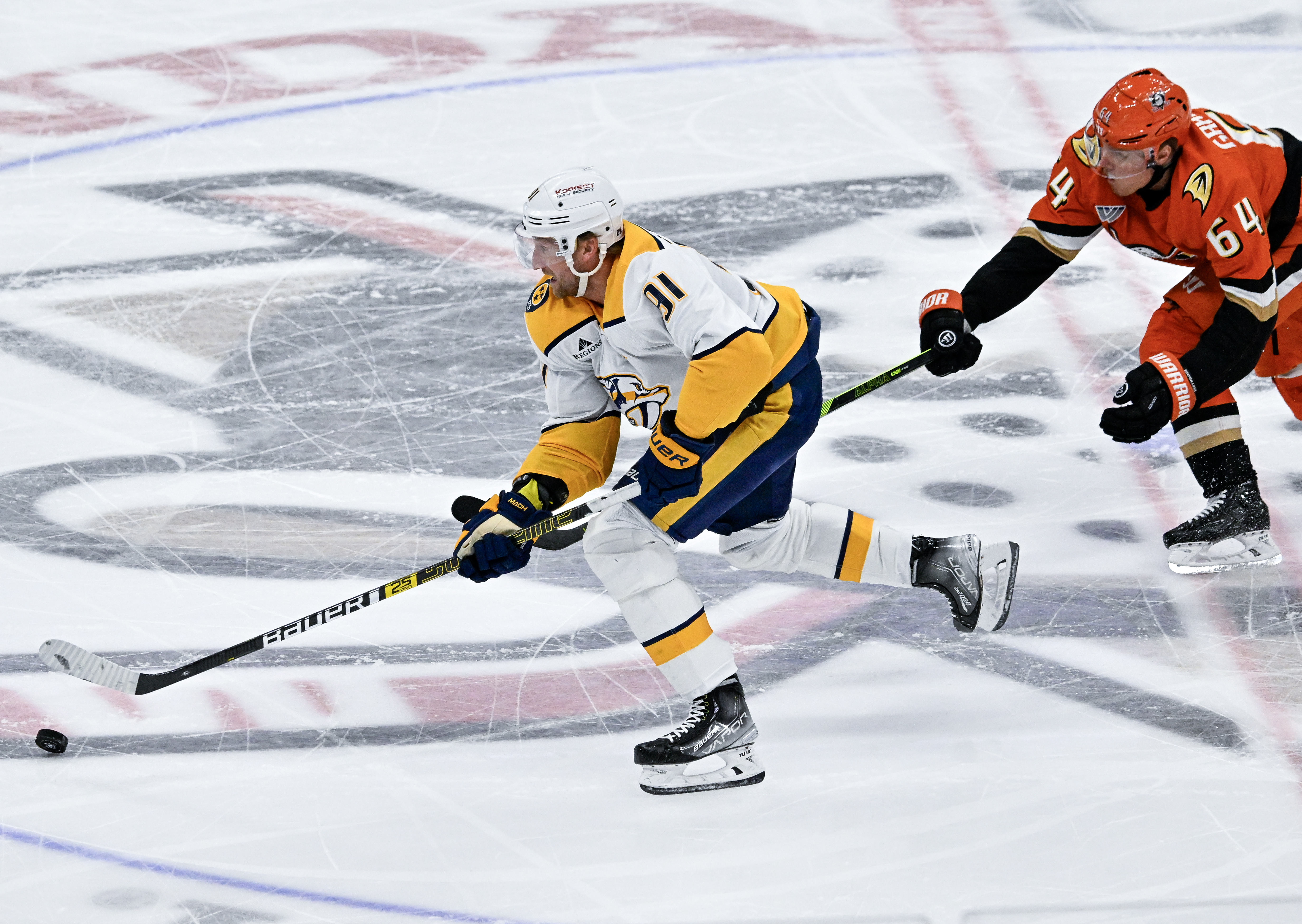 The Nashville Predators’ Steven Stamkos, left, brings the puck up...