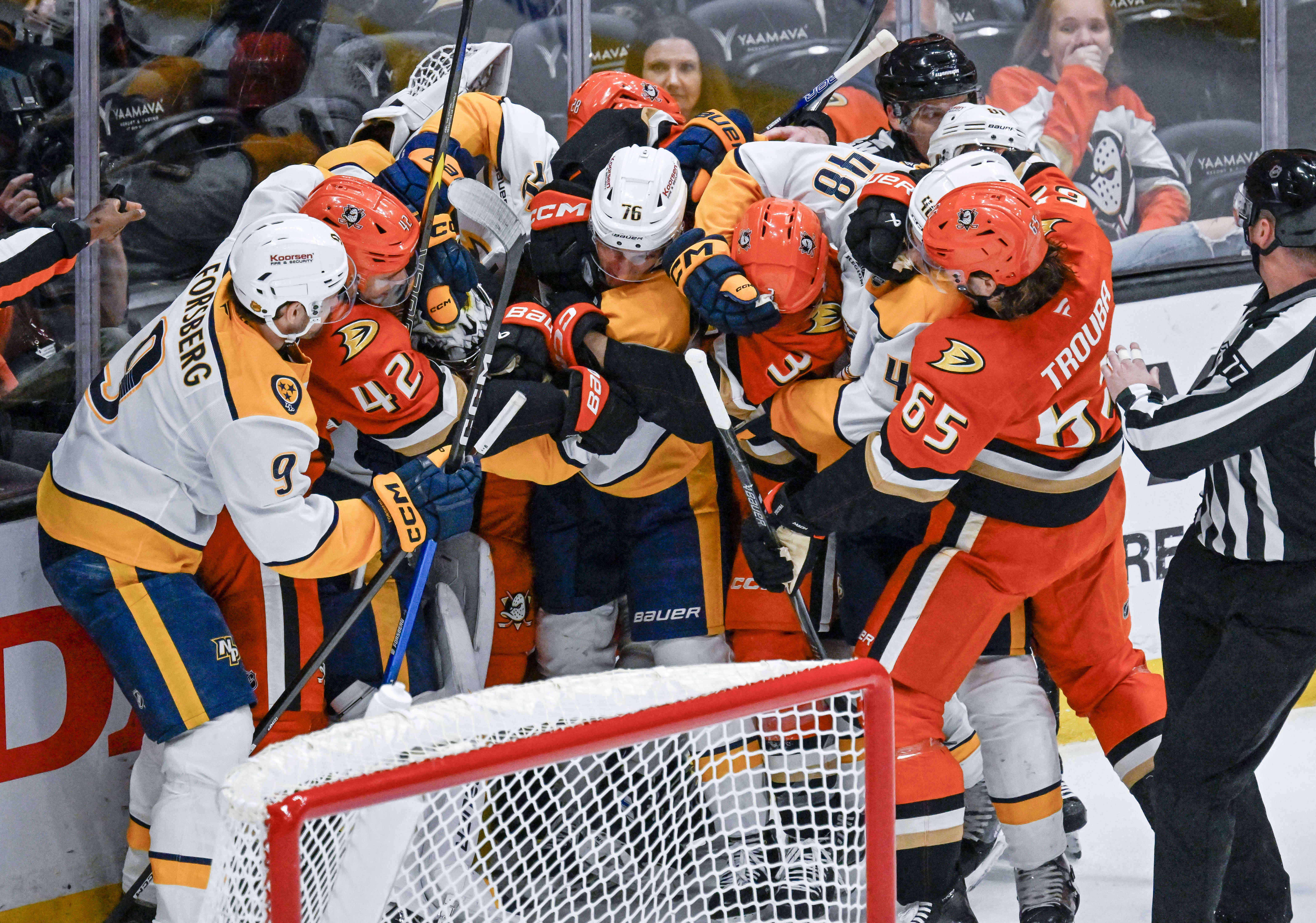 Ducks and Nashville Predators players get into a scuffle behind...