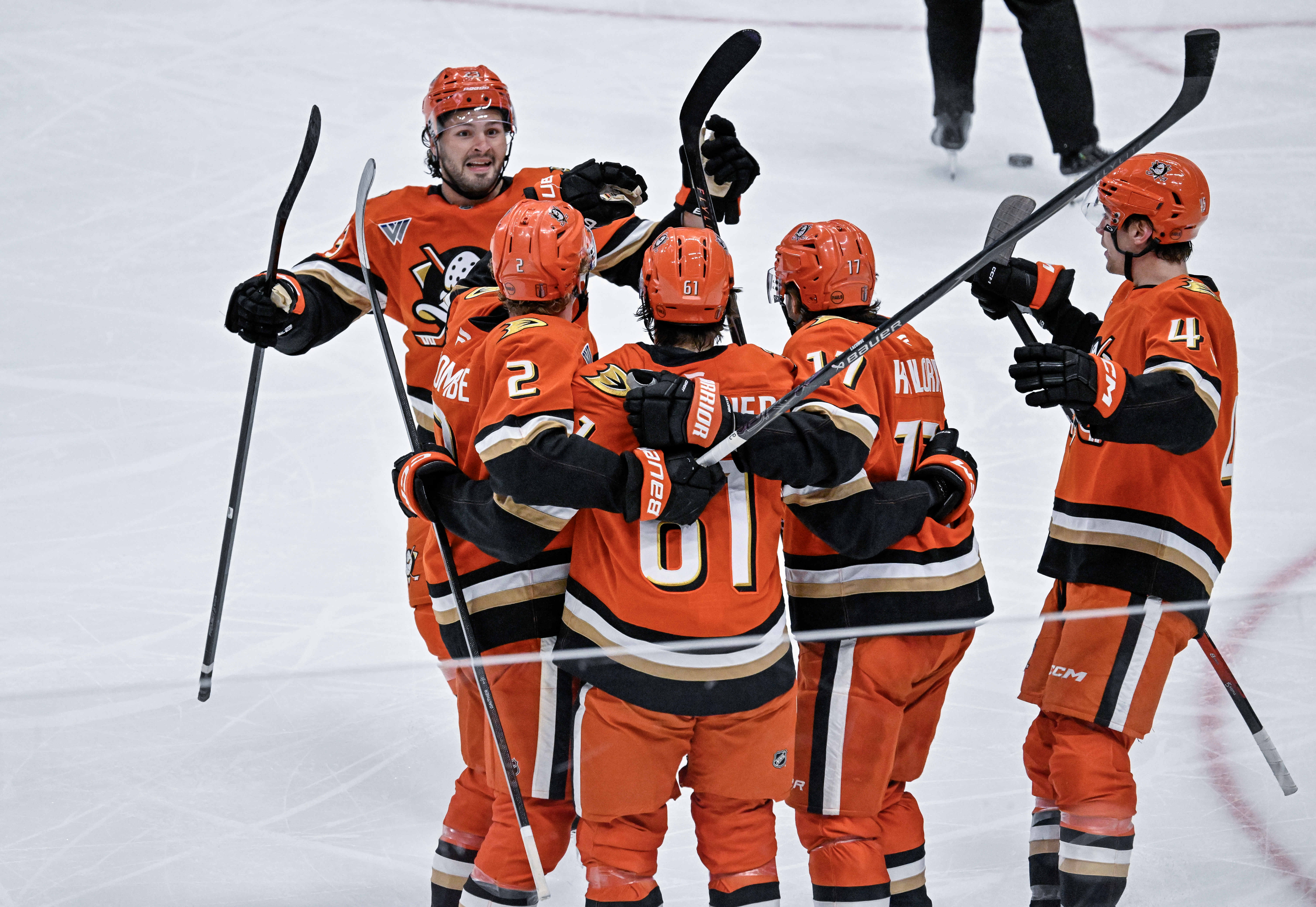 Ducks players celebrate a second period goal by Cutter Gauthier...