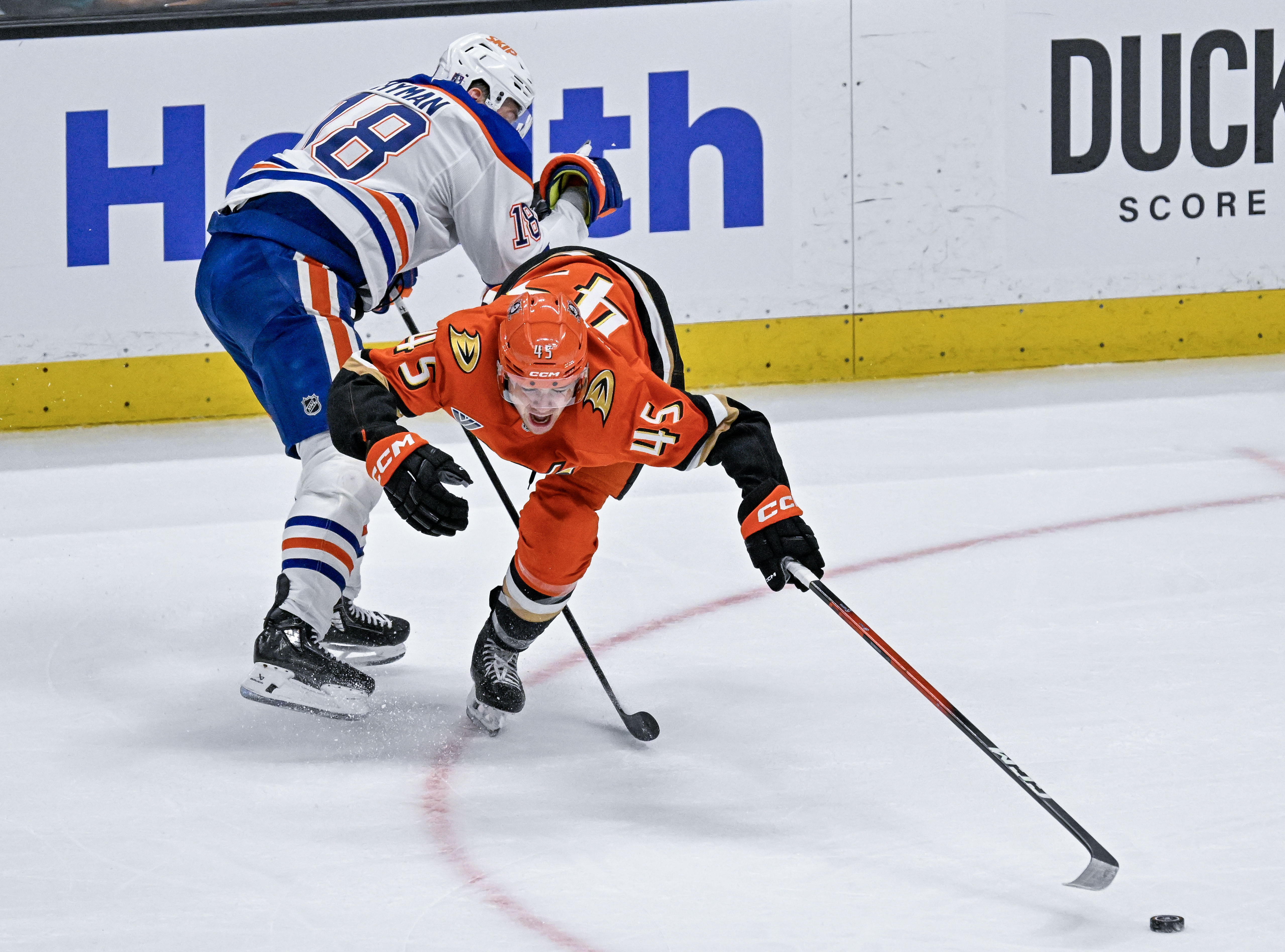 The Oilers Zach Hyman (18), left, upends the Ducksâ Beckett...