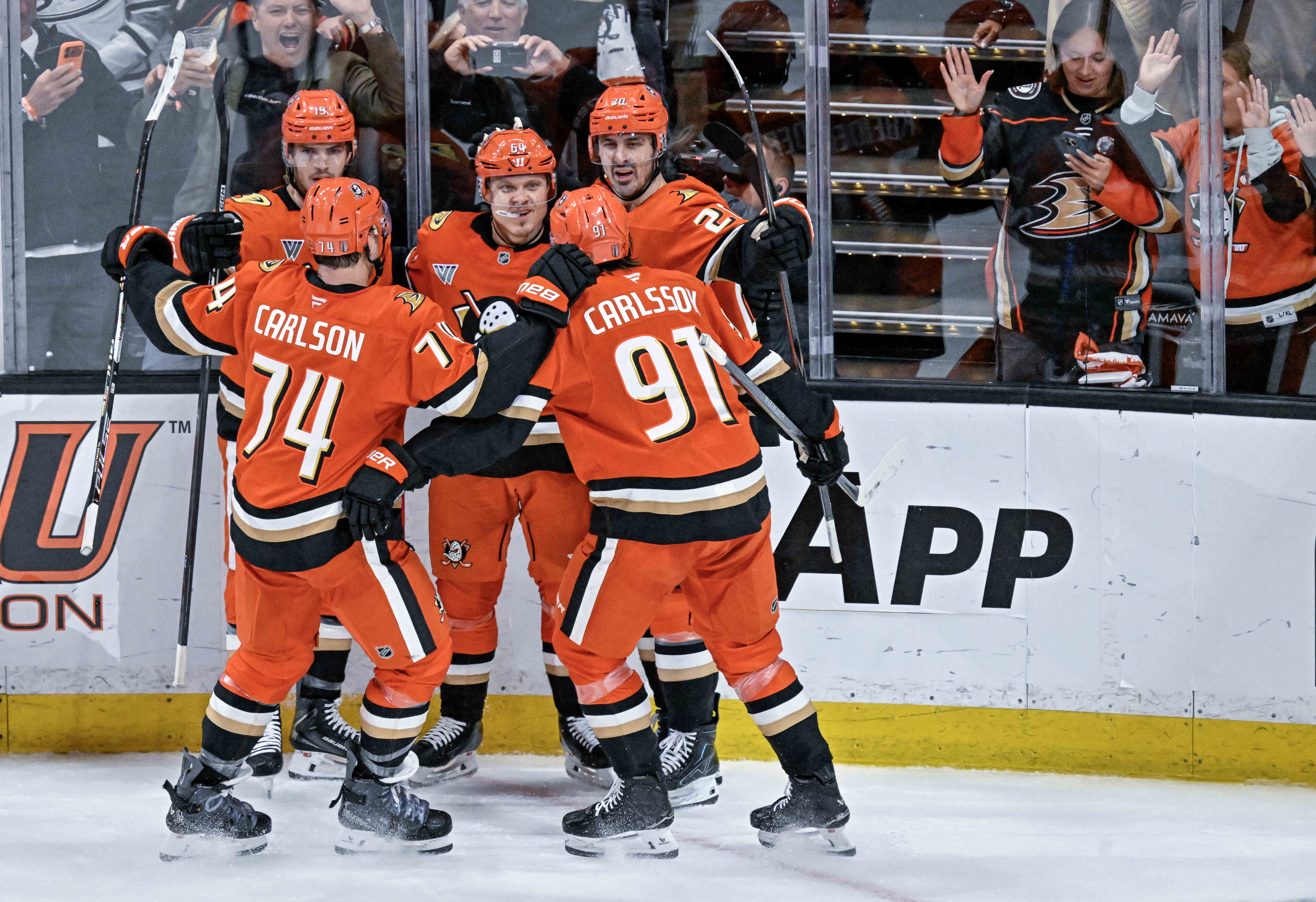 Ducks players celebrate a second period goal by Mikael Granlund...