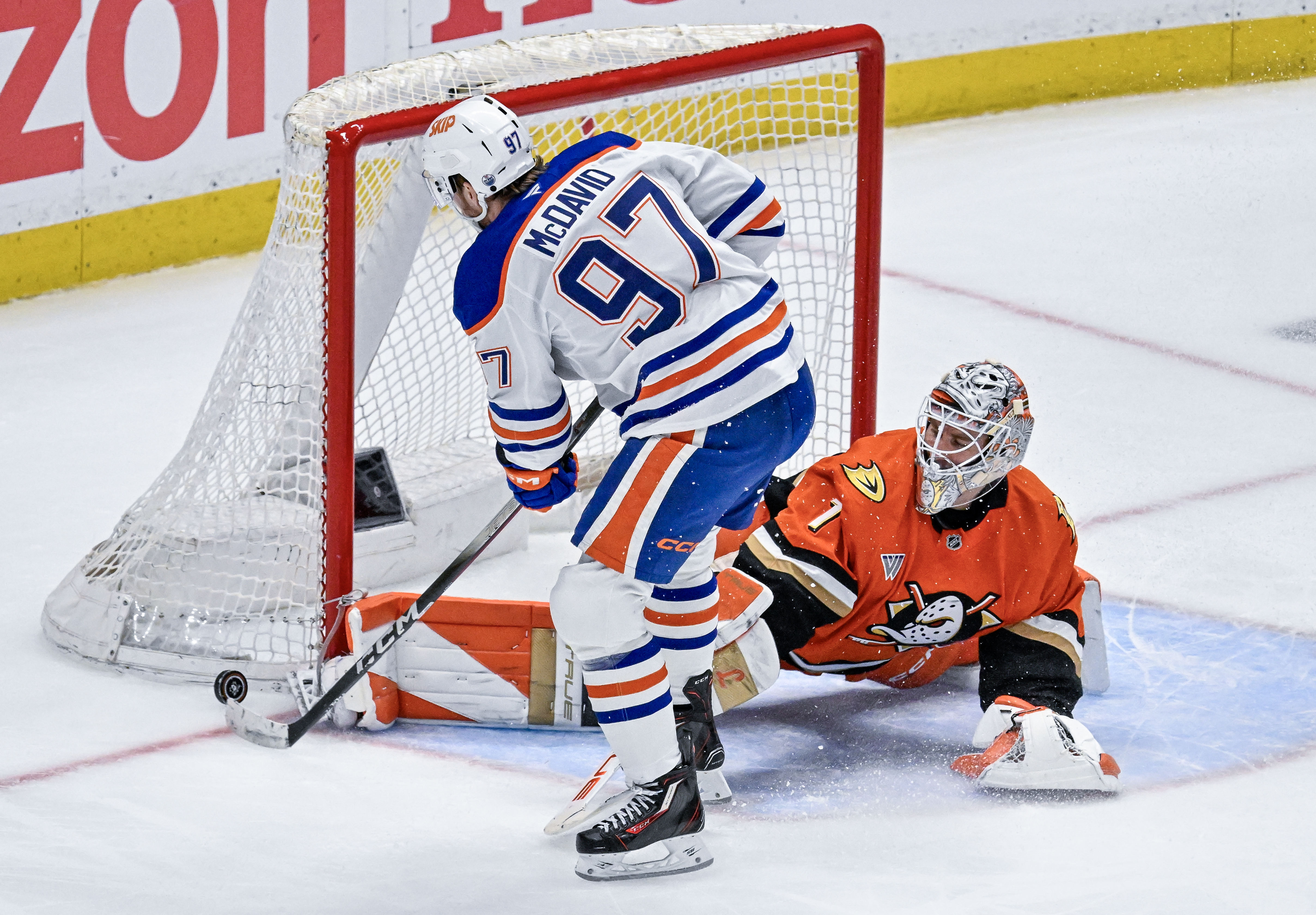 Ducks goalie Lukas Dostal (1) lays out on the ice...
