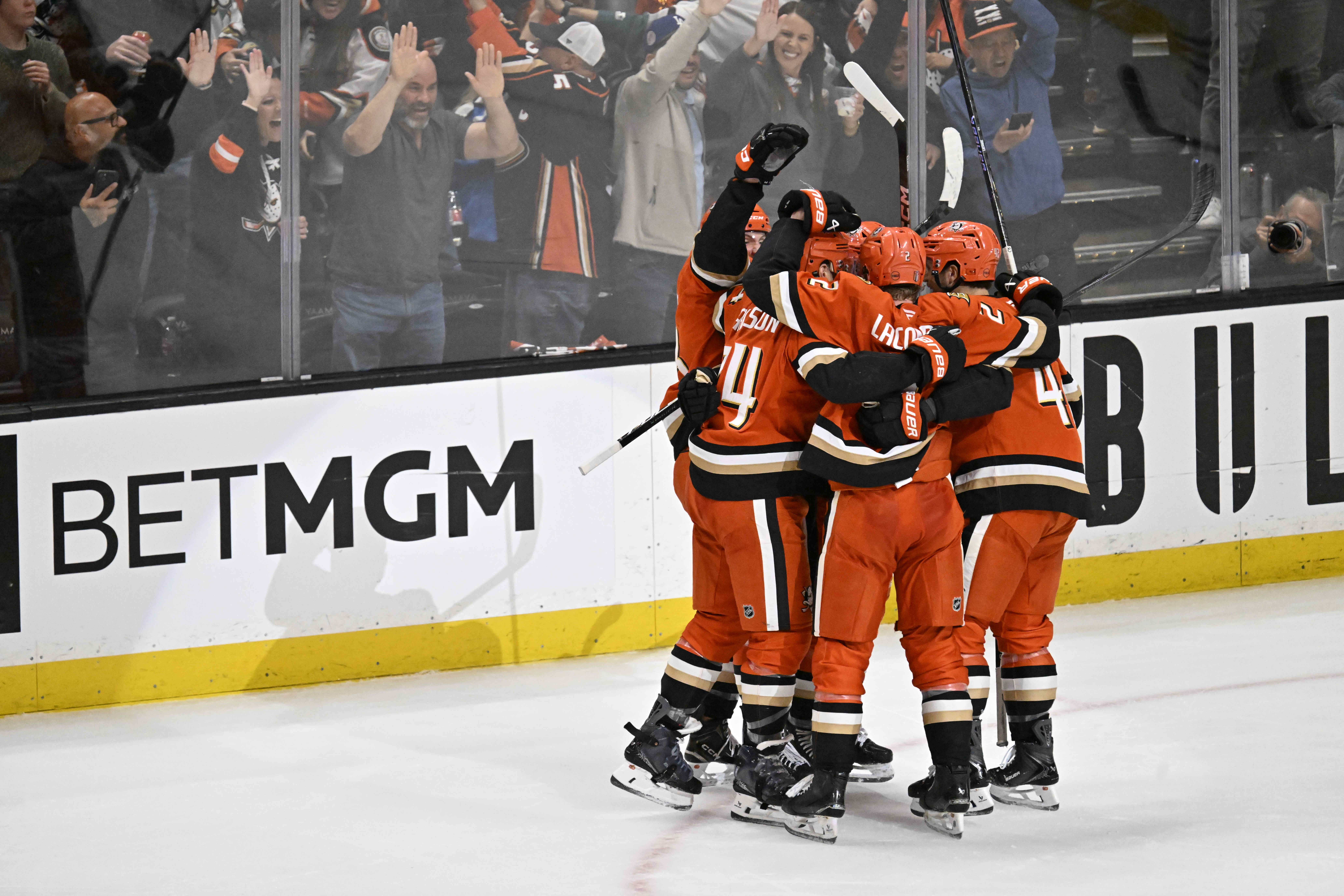 Ducks players celebrate a third period goal by Jeffrey Viel...