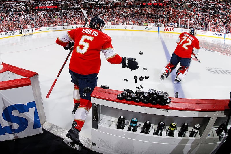 SUNRISE, FLORIDA - JUNE17: Aaron Ekblad #5 of the Florida Panthers slaps the warm-up pucks onto the ice prior to the start of the game against the Edmonton Oilers in Game Six of the 2025 Stanley Cup Final at the Amerant Bank Arena on June 17, 2025 in Sunrise, Florida. (Photo by Eliot J. Schechter/NHLI via Getty Images)