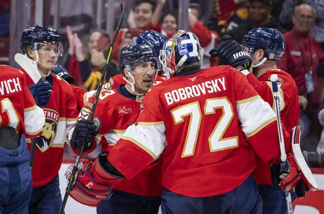 Florida Panthers goaltender Sergei Bobrovsky (72) and left wing Brad Marchand (63) celebrate after they defeated the Carolina Hurricanes in their NHL game at Amerant Bank Arena on Friday, Dec. 19, 2025, in Sunrise, Fla.