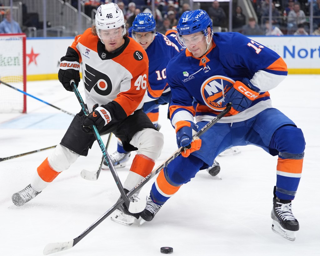 Mathew Barzal battles for Trevor Zegras for the puck during the Islanders' loss to the Flyers on April 3, 2026  at UBS Arena.
