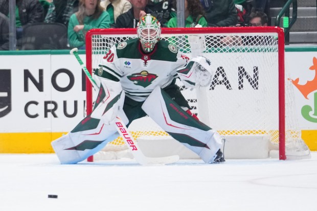 Jesper Wallstedt guards his net during the second period in Game 1 of a first-round NHL Stanley Cup playoffs hockey series between the Dallas Stars and the Minnesota Wild, Saturday, April 18, 2026, in Dallas. (AP Photo/Julio Cortez)