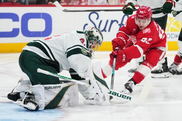 Minnesota Wild goaltender Filip Gustavsson (32) stops a Detroit Red Wings center Marco Kasper (92) shot in the second period of an NHL hockey game Sunday, April 5, 2026, in Detroit. (AP Photo/Paul Sancya)