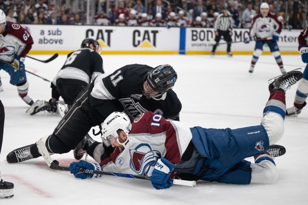 Center Anze Kopitar (11) of the Los Angeles Kings falls down on center Nicolas Roy (10) of the Colorado Avalanche in a face-off during Game 4 of the first round of the Stanley Cup Playoffs on Sunday, April 26, 2026, at Crypto.com Arena in Los Angeles, Calif. (Photo by Timothy Hurst/The Denver Post)