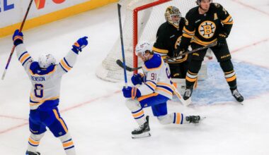 Sabres winger Josh Doan (91) goes to a knee to celebrates his goal with teammate Zach Benson (left) in front of Bruins goalie Jeremy Swayman and defenseman Charlie McAvoy after his power-play tally gave Buffalo an early 2-0 lead.