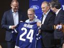 From left, Maple Leafs general manager Brad Treliving, CEO Keith Pelley, coach Craig Berube and president Brendan Shanahan announce the hiring of Berube on May 21, 2024.   