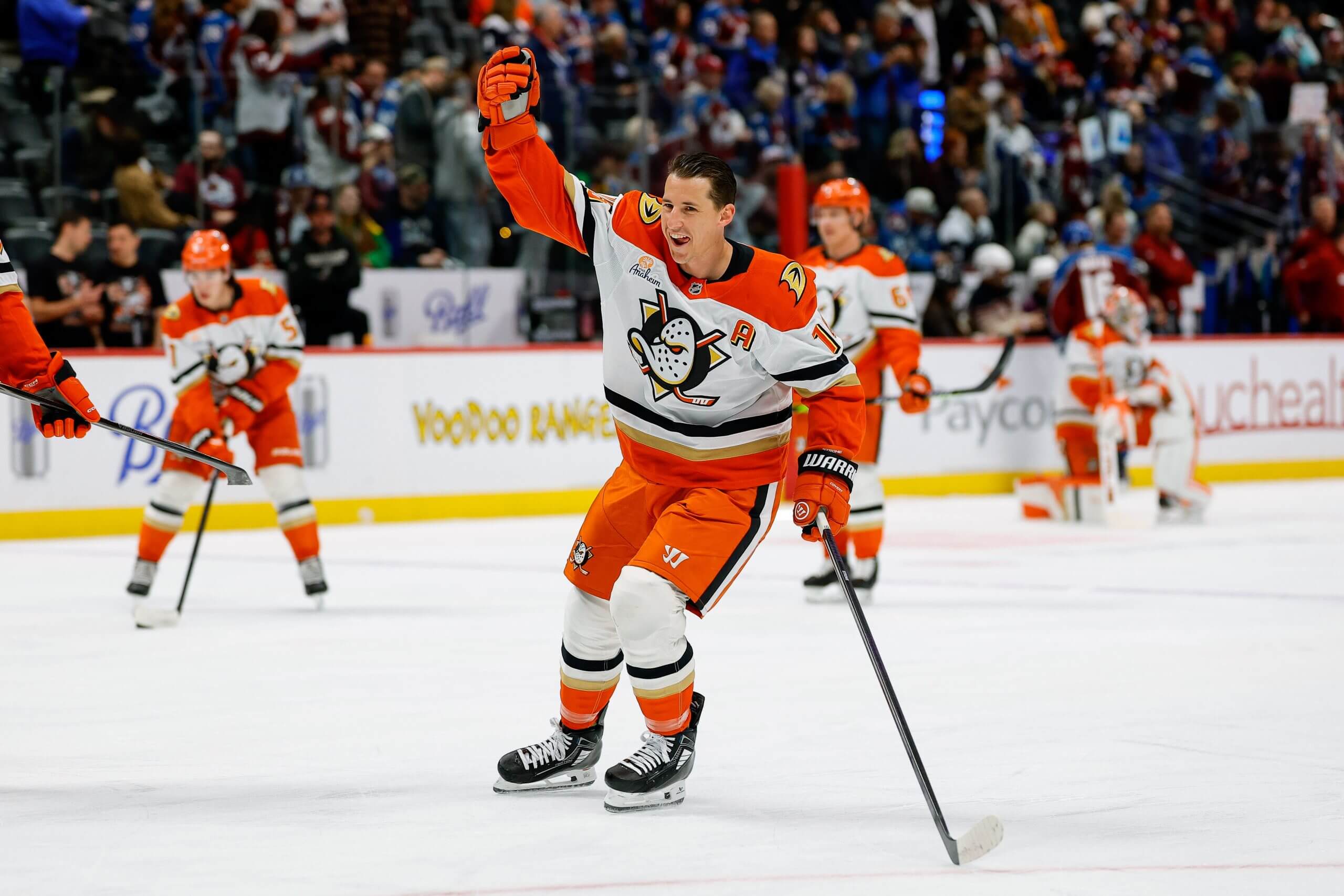 Ryan Strome holds one hand up while smiling during warmups before a Ducks game.
