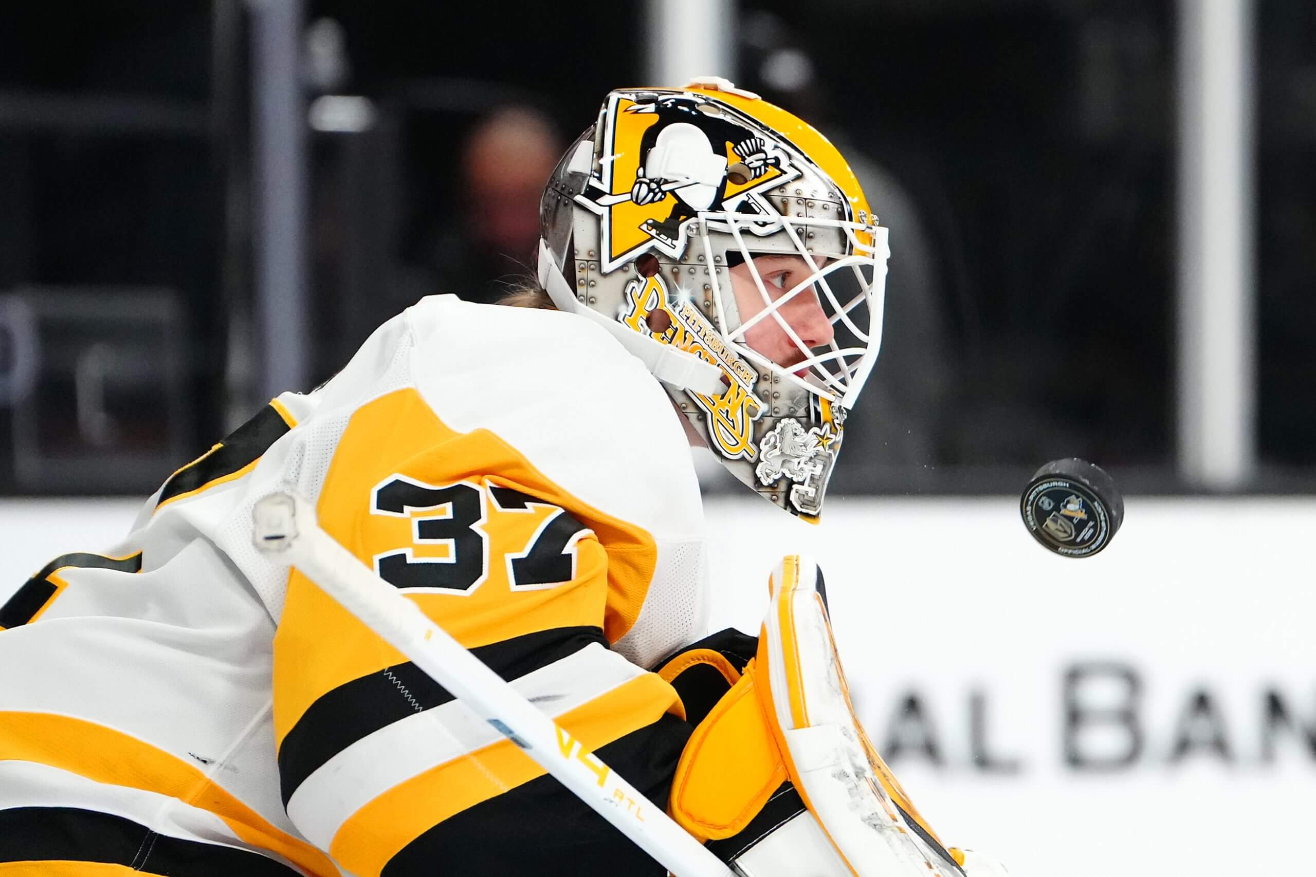 Arturs Silovs stares straight forward while a puck flies at his chest.
