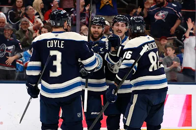 Columbus Blue Jackets players celebrate goal during 2026 game.
