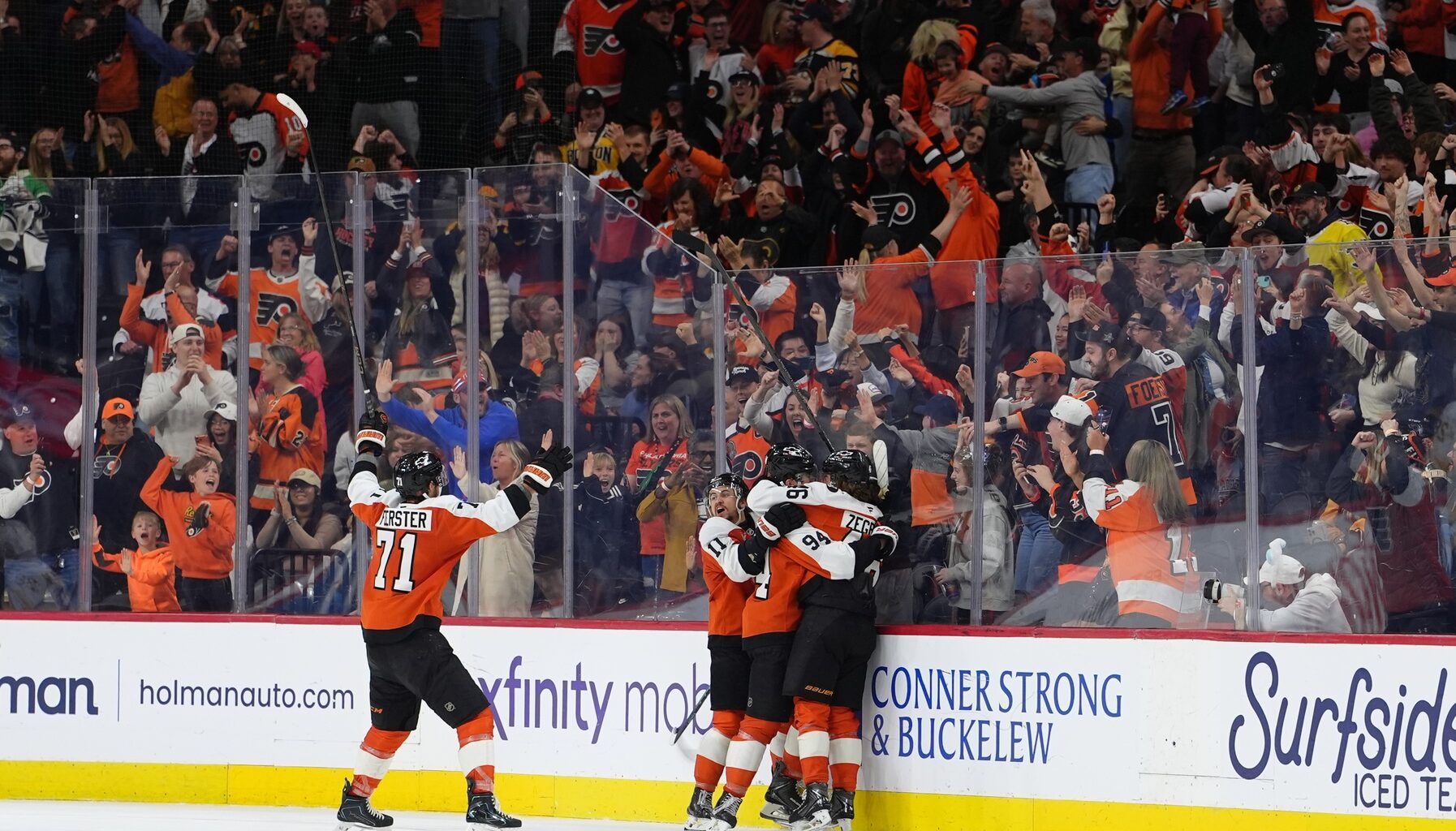 Apr 5, 2026; Philadelphia, Pennsylvania, USA; Philadelphia Flyers right wing Porter Martone (94) celebrates with teammates after scoring a goal against the Boston Bruins in overtime at Xfinity Mobile Arena.