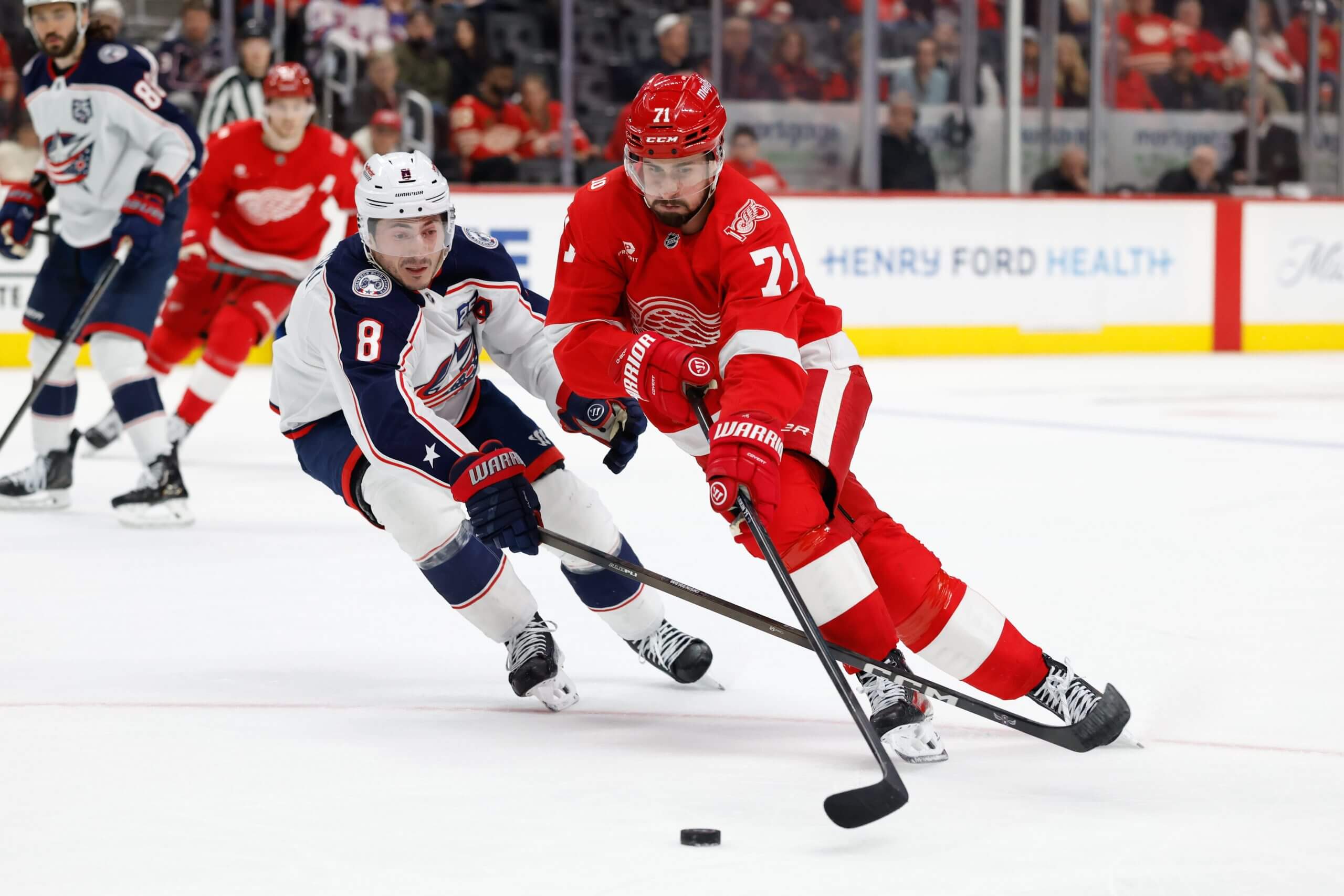 Dylan Larkin moves the puck away from Blue Jackets defenseman Zach Werenski.