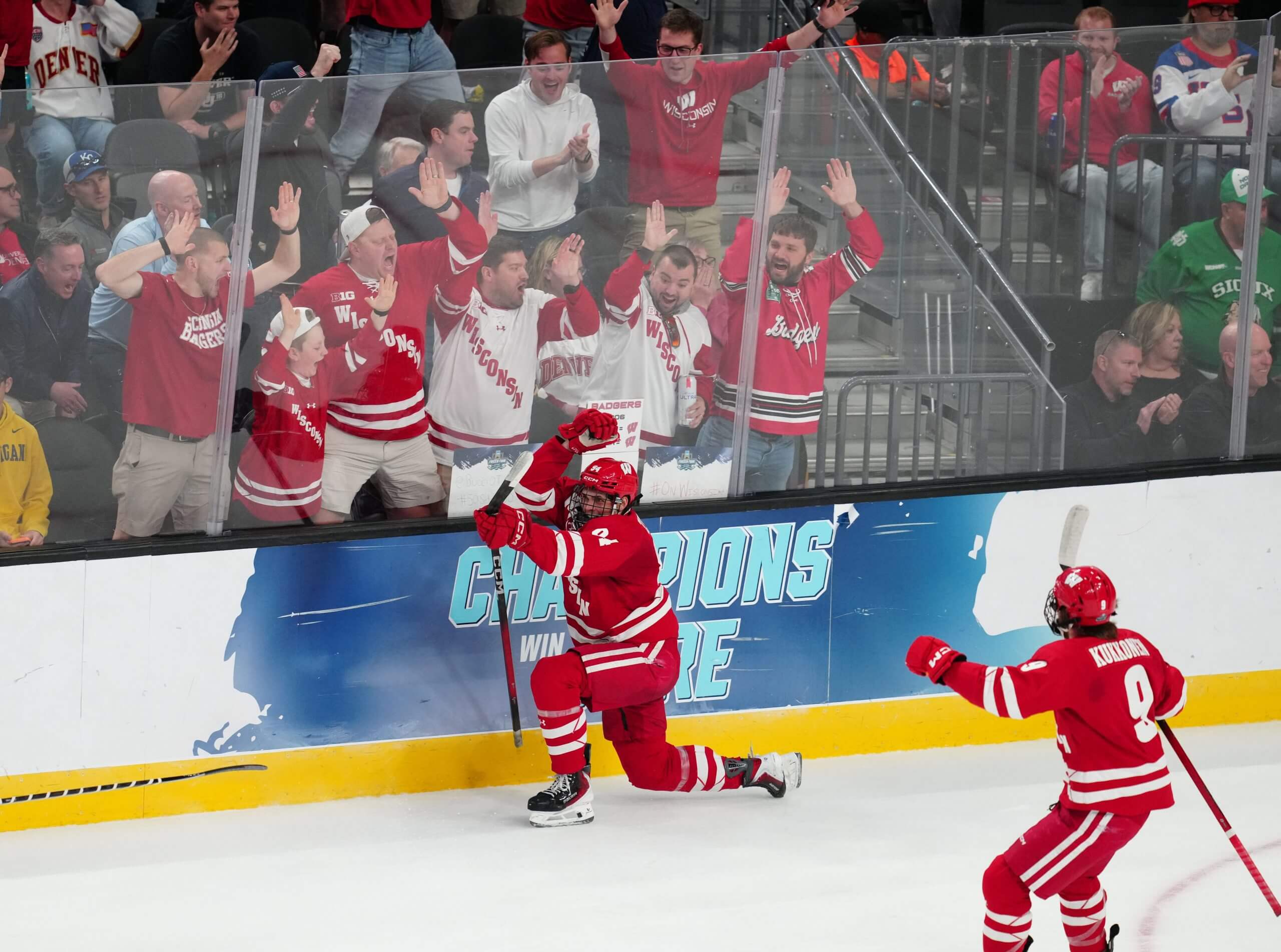 Vasily Zelenov celebrates along the glass after scoring for Wisconsin.