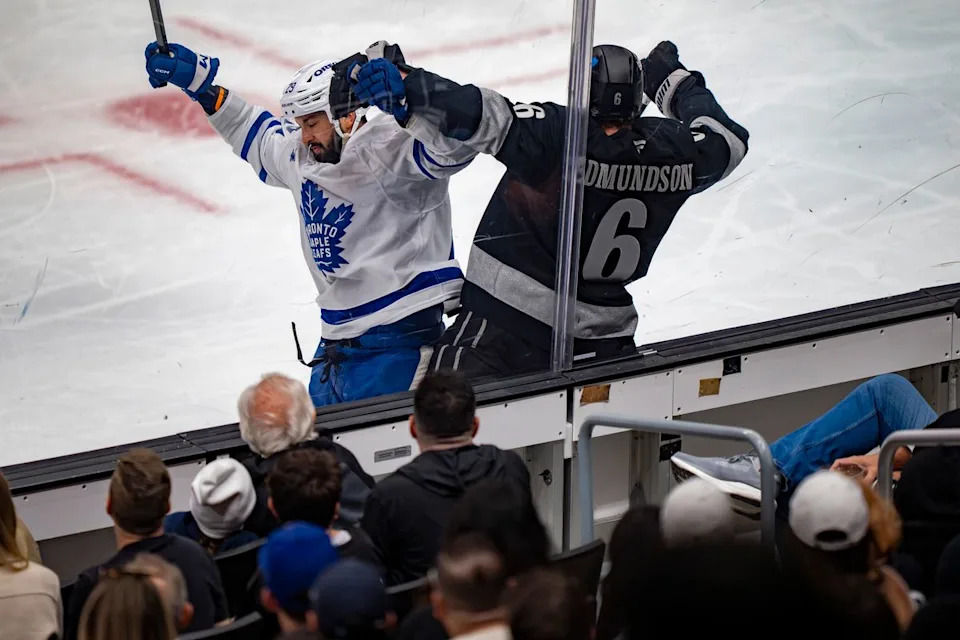 Los Angeles Kings defenseman Joel Edmundson (6) being crushed against the glass during an NHL hockey game against the Toronto Maple Leafs on April 4th, 2026 in Los Angeles, CA.
