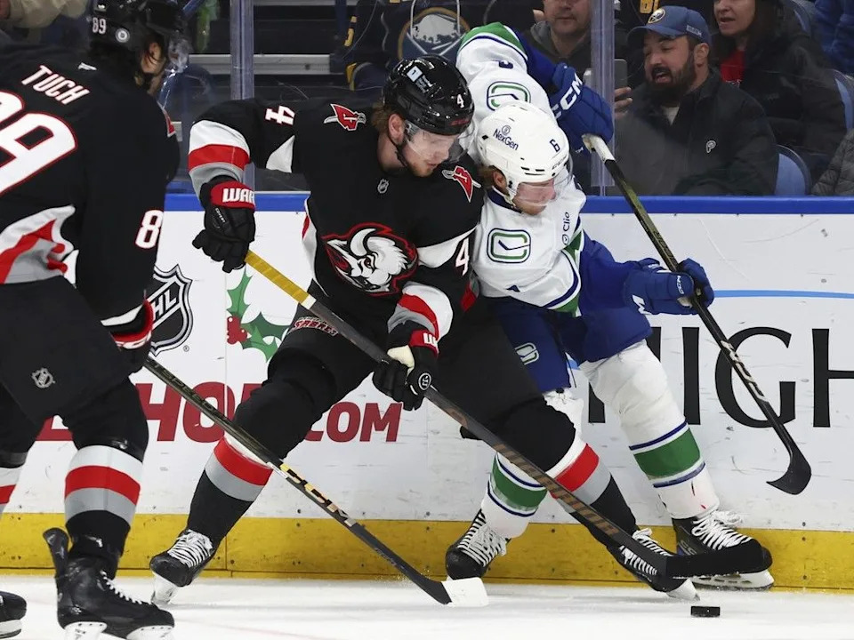  Sabres defenceman Bowen Byram and Brock Boeser battle for puck possession on Nov. 29, 2024, in Buffalo, N.Y.