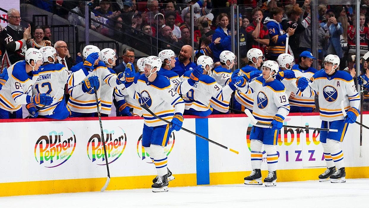 Buffalo Sabres' Mattias Samuelsson celebrating a goal with teammates on the bench during a hockey game in Ottawa