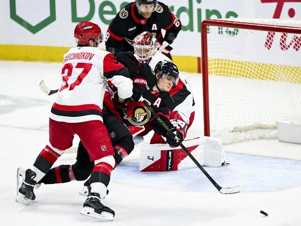  The Ottawa Senators’ Tim Stutzle falls to the ice as he tries to play the puck in front of Carolina Hurricanes goaltender Frederik Andersen during the third period in Ottawa on Sunday, April 5, 2026.