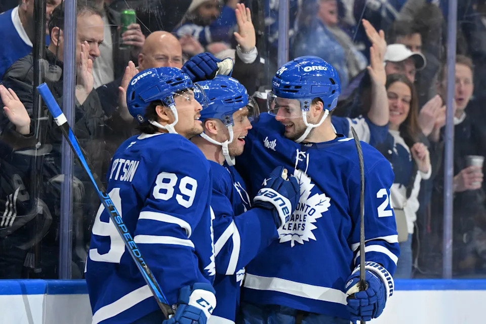 Toronto Maple Leafs forward Max Domi (center) celebrates with forwards Nick Robertson (89) and Scott Laughton.Dan Hamilton-Imagn Images