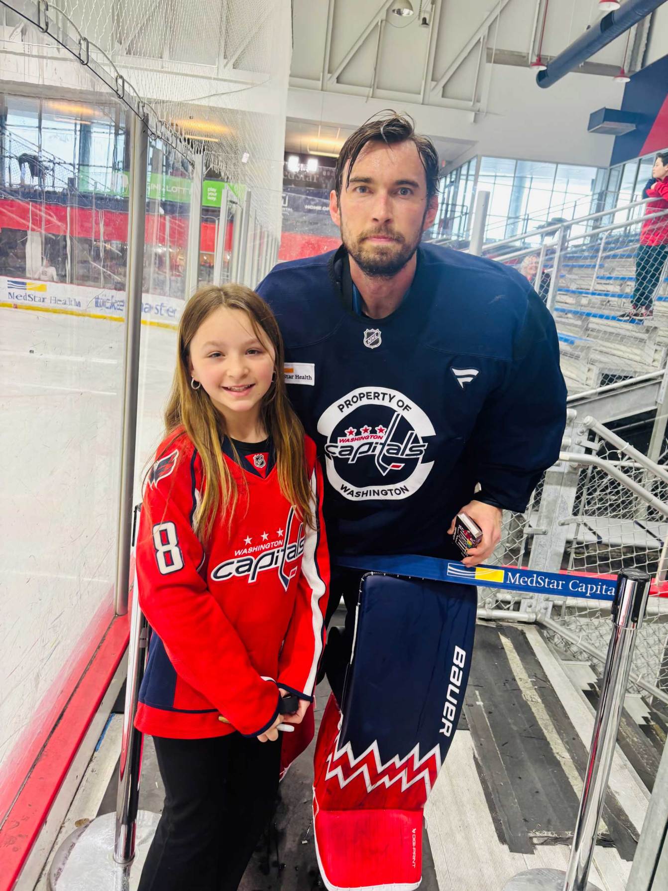 Charlie Lindgren takes a photo with a Capitals fan