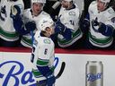 Vancouver Canucks right wing Brock Boeser, front, is congratulated as he passes the team box after scoring his third goal of the night on April 1, 2026.