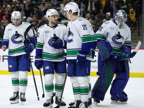 Vancouver Canucks players talk during the third period of an NHL hockey game against the Minnesota Wild on April 2, 2026.
