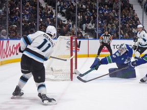 Utah Mammoth's Dylan Guenther scores against Vancouver Canucks goalie Nikita Tolopilo