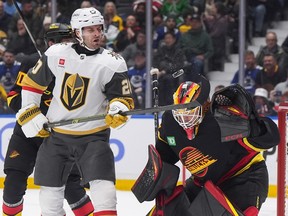 Vegas Golden Knights' Brandon Saad, front left, redirects the puck with his stick in front of Vancouver Canucks goalie Nikita Tolopilo during the first period at Rogers Arena on Tuesday, April 7, 2026. The Knights won 2-1.