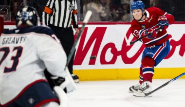 Hockey player whips a shot to score on the goaltender.