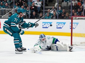 Vancouver Canucks goaltender Kevin Lankinen, right, blocks a shot by San Jose Sharks center Macklin Celebrini on April 11, 2026.