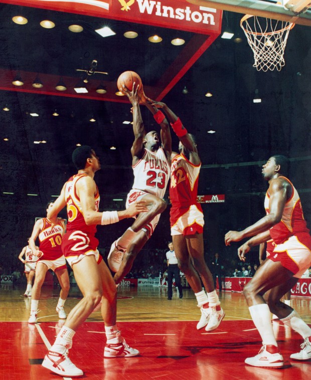 Michael Jordan draws a foul from Atlanta's Kevin Willis during the first period on April 16, 1987. (Bob Langer/Chicago Tribune)