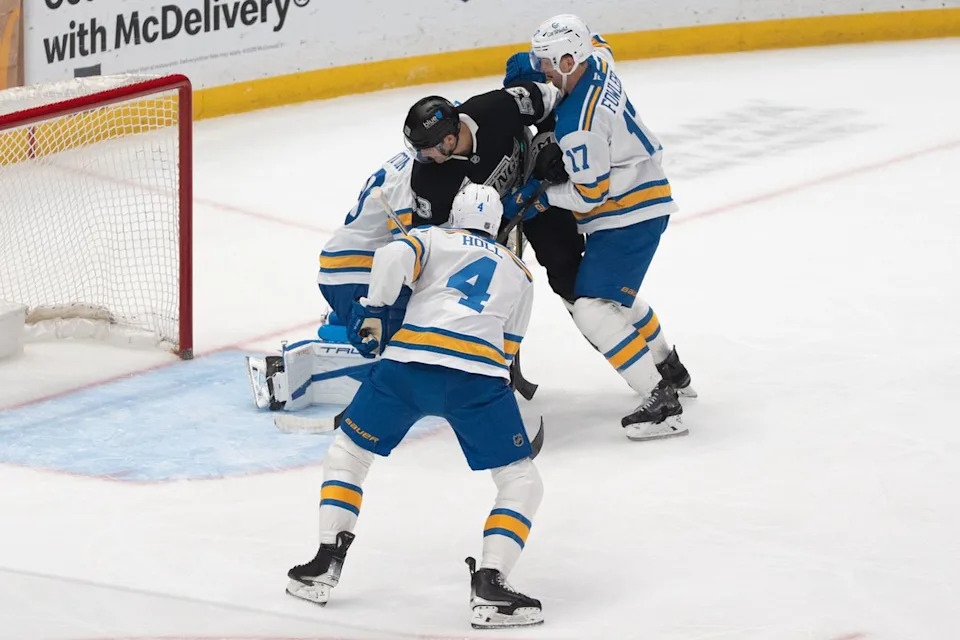 Los Angeles Kings Right Wing Jared Wright (53) takes on two players while trying to score a goal during an NHL match against the St. Louis Blues on April 1st, 2026 in Los Angeles, California.