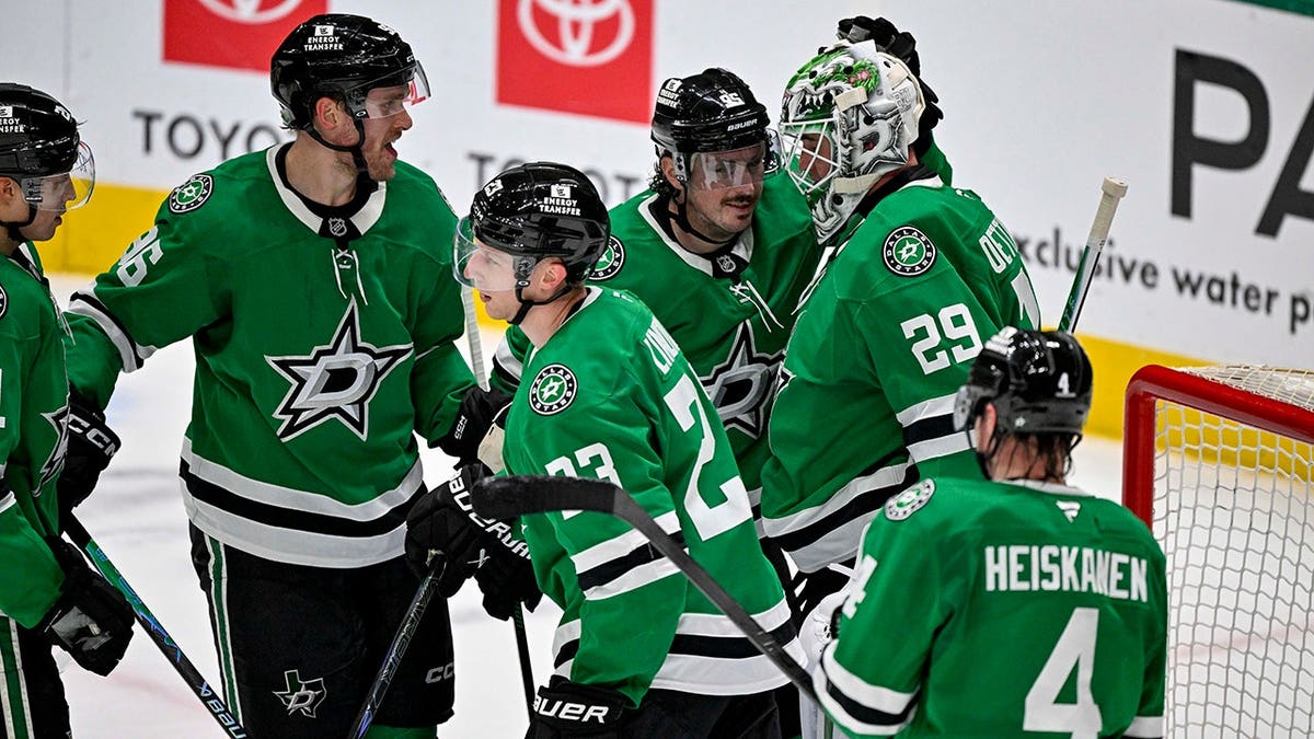 Dallas Stars players Mikko Rantanen, Matt Duchene, Esa Lindell, Jake Oettinger, and Miro Heiskanen celebrating on ice.