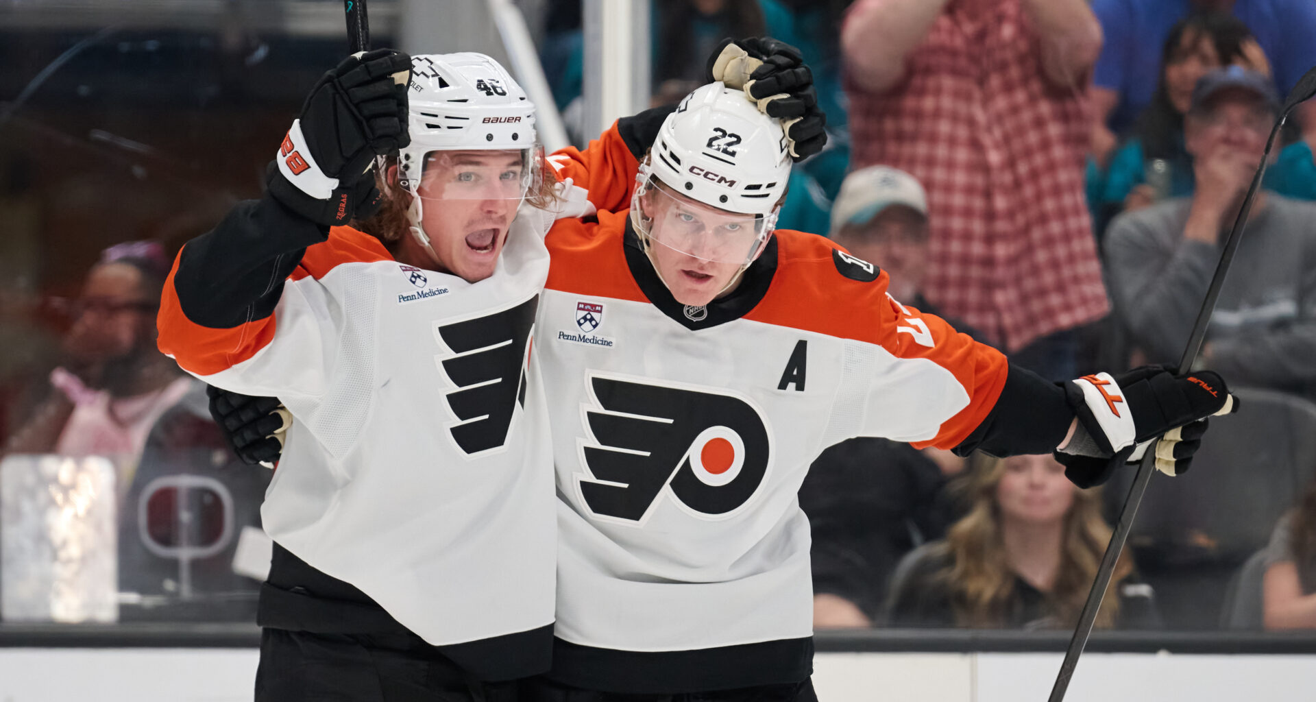 Philadelphia Flyers center Christian Dvorak (22) celebrates with center Trevor Zegras (46) at SAP Center at San Jose.