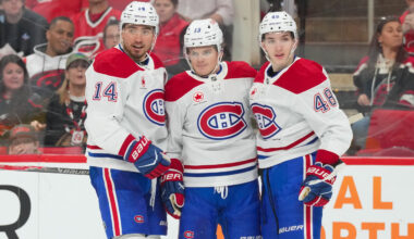 Montreal Canadiens center Nick Suzuki (14) is congratulated by defenseman Lane Hutson (48) and right wing Cole Caufield (13) at Lenovo Center