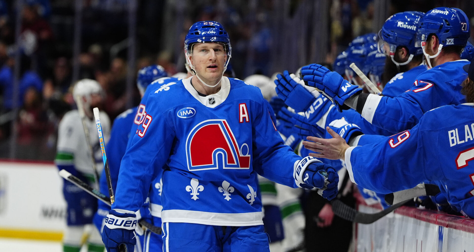 Colorado Avalanche center Nathan MacKinnon (29) celebrates a goal against the Vancouver Canucks at Ball Arena