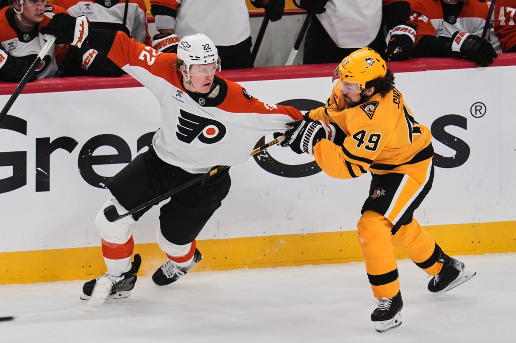 Christian Dvorak being defended by Samuel Girard during an NHL Stanley Cup playoff game.