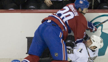 Hockey player checks an opponent intothe boards.