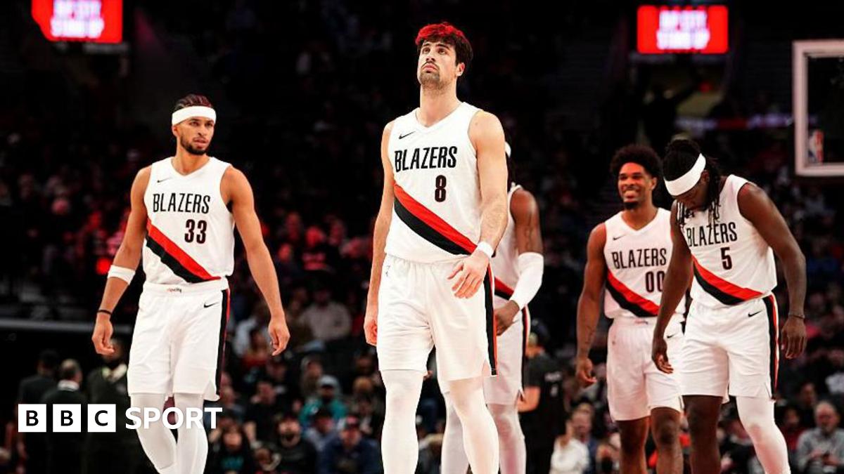 Portland Trail Blazers players Toumani Camara, Robert Williams III, Deni Avdija, Scoot Henderson and Jrue Holiday walk onto the court during a timeout