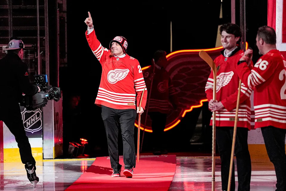 Darren McCarty waves at fans during a ceremony to honor Stanley Cup champion team members from 1996-97, 1997-98, and 2001-02 seasons at Little Caesars Arena in Detroit on Saturday, Jan. 31, 2026.